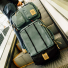 Topo Designs Global Travel Bag Roller Sea Pine on an escalator